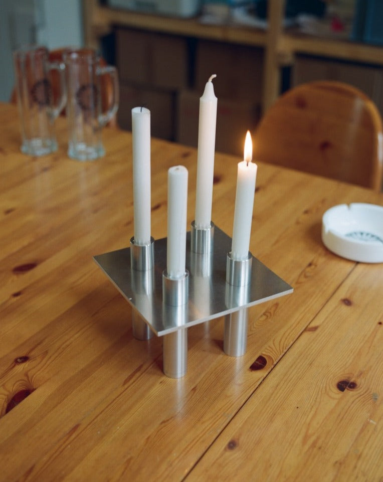 P-L series four-position candelabra made of aluminum on a table