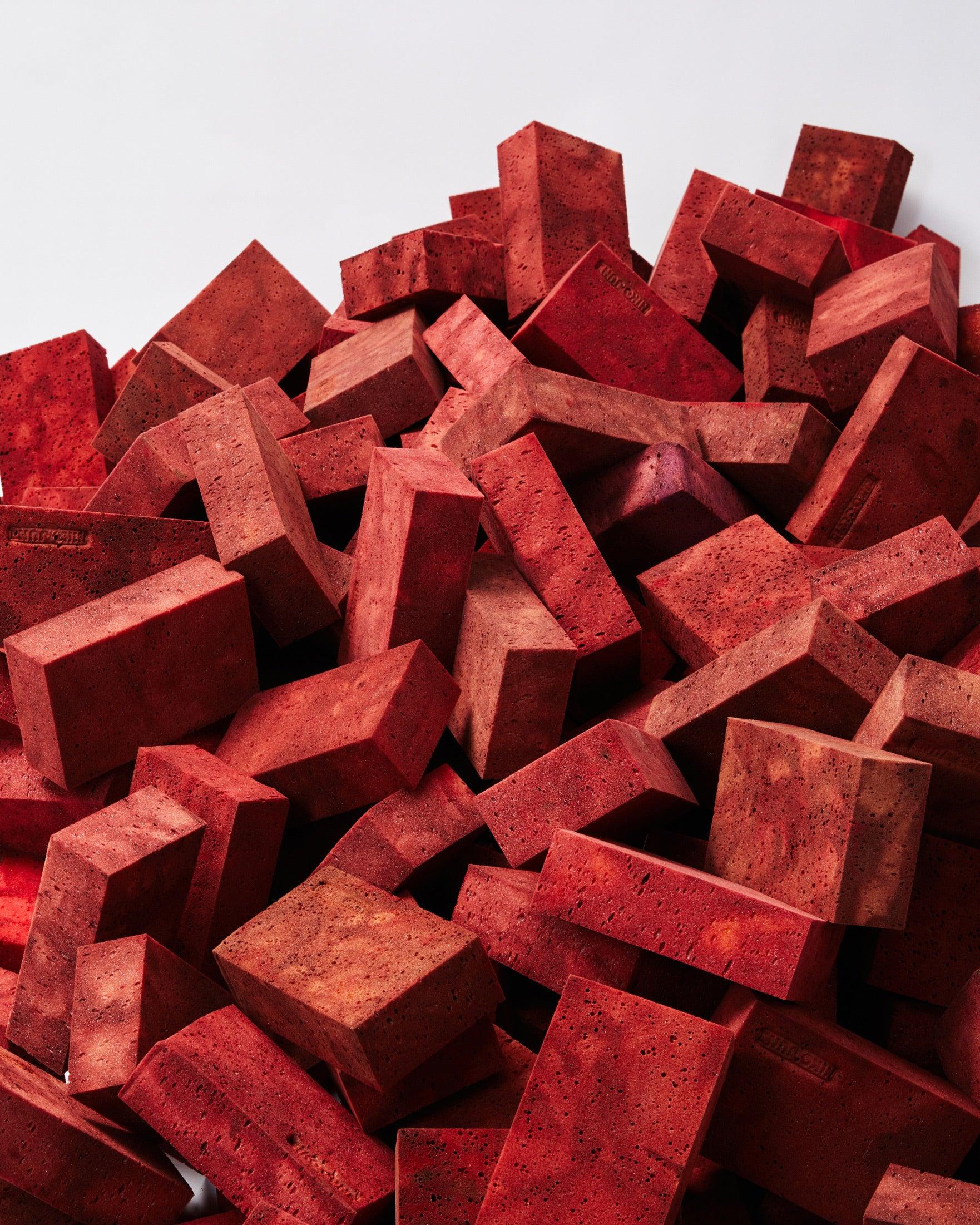 Messy structure of red bricks with white background