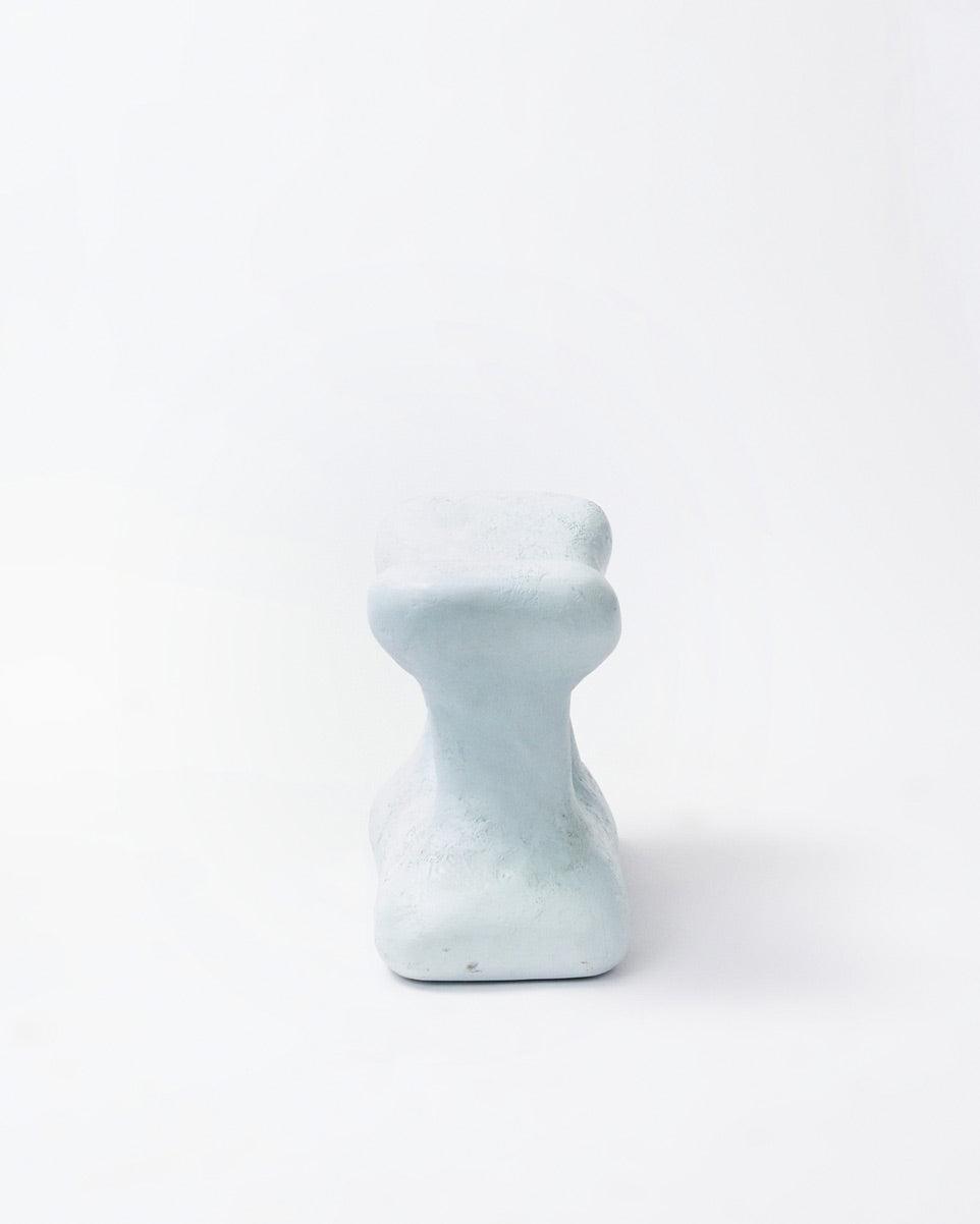 Hand-carved collectible white stool by NIKO JUNE in frontal position in white background