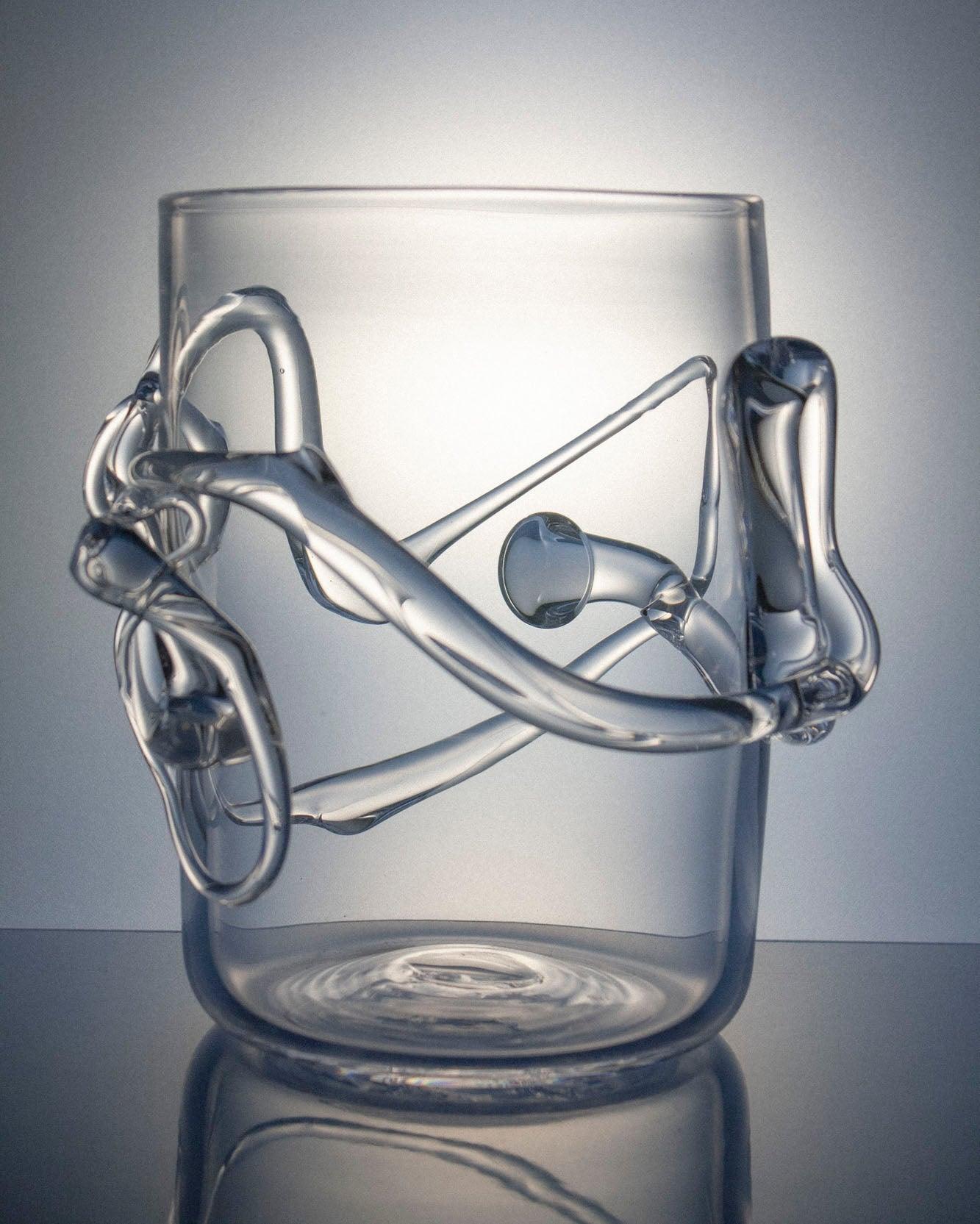 Glass vase with melted glass design on a white and gray shadow background