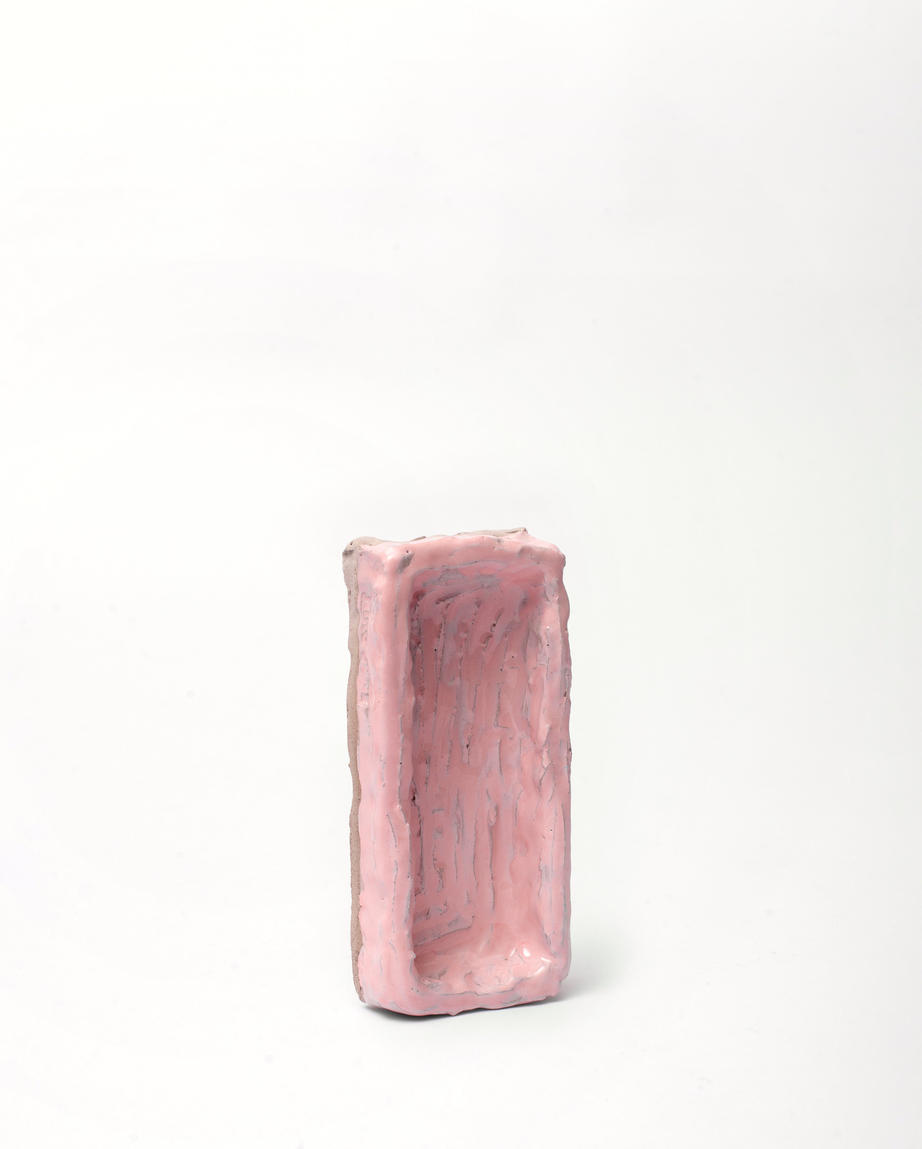Handmade ceramic organizer object pink in vertical position on white background