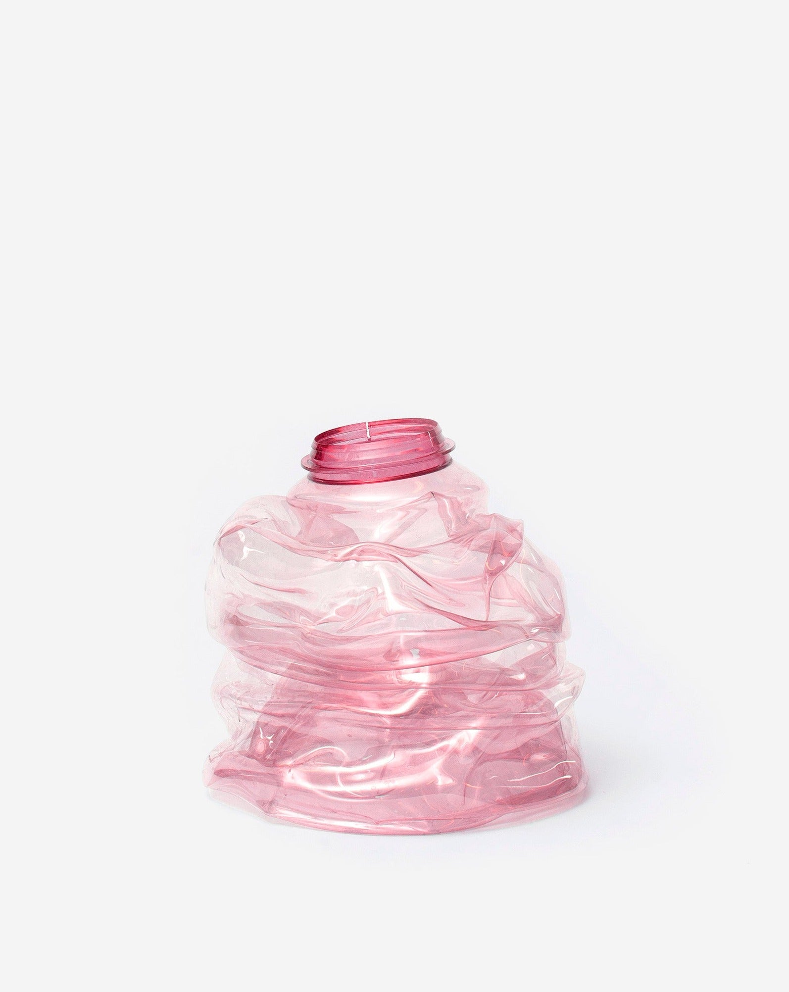 Small pink handmade recycled plastic vase on white background