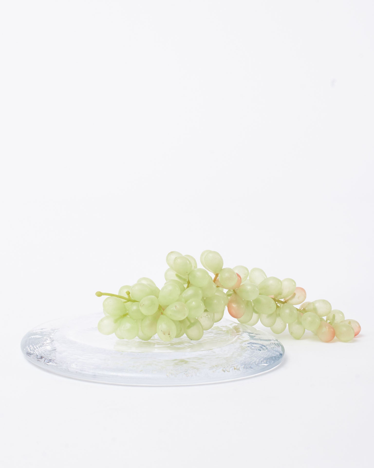 Glass plate design modern on the top green grapes in white background
