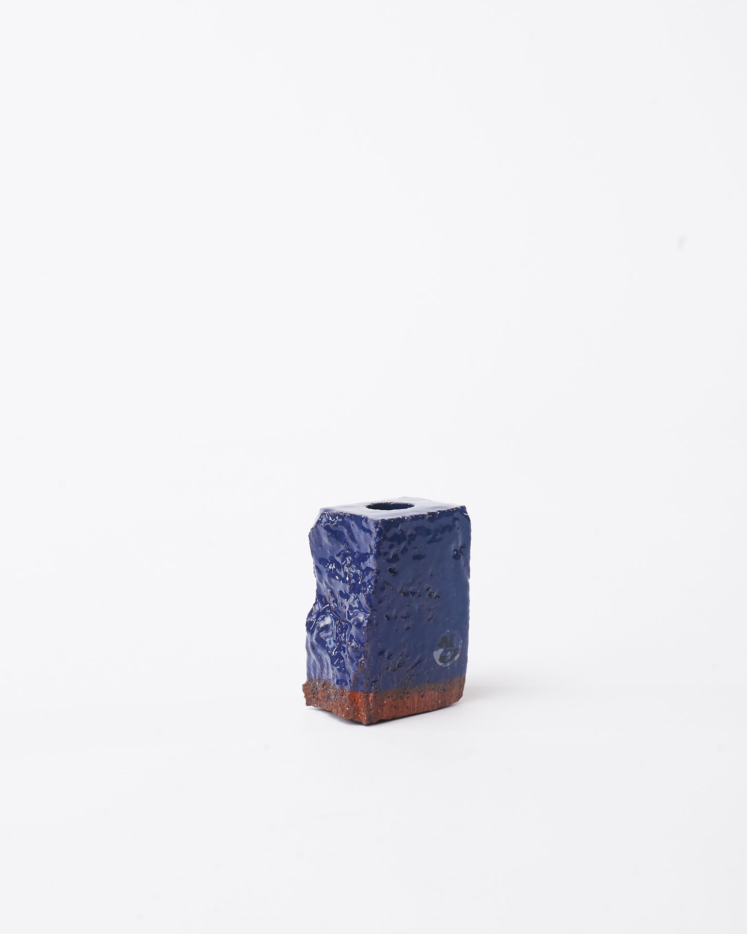 Handmade dark blue brick ceramic candle holder small in white background 
