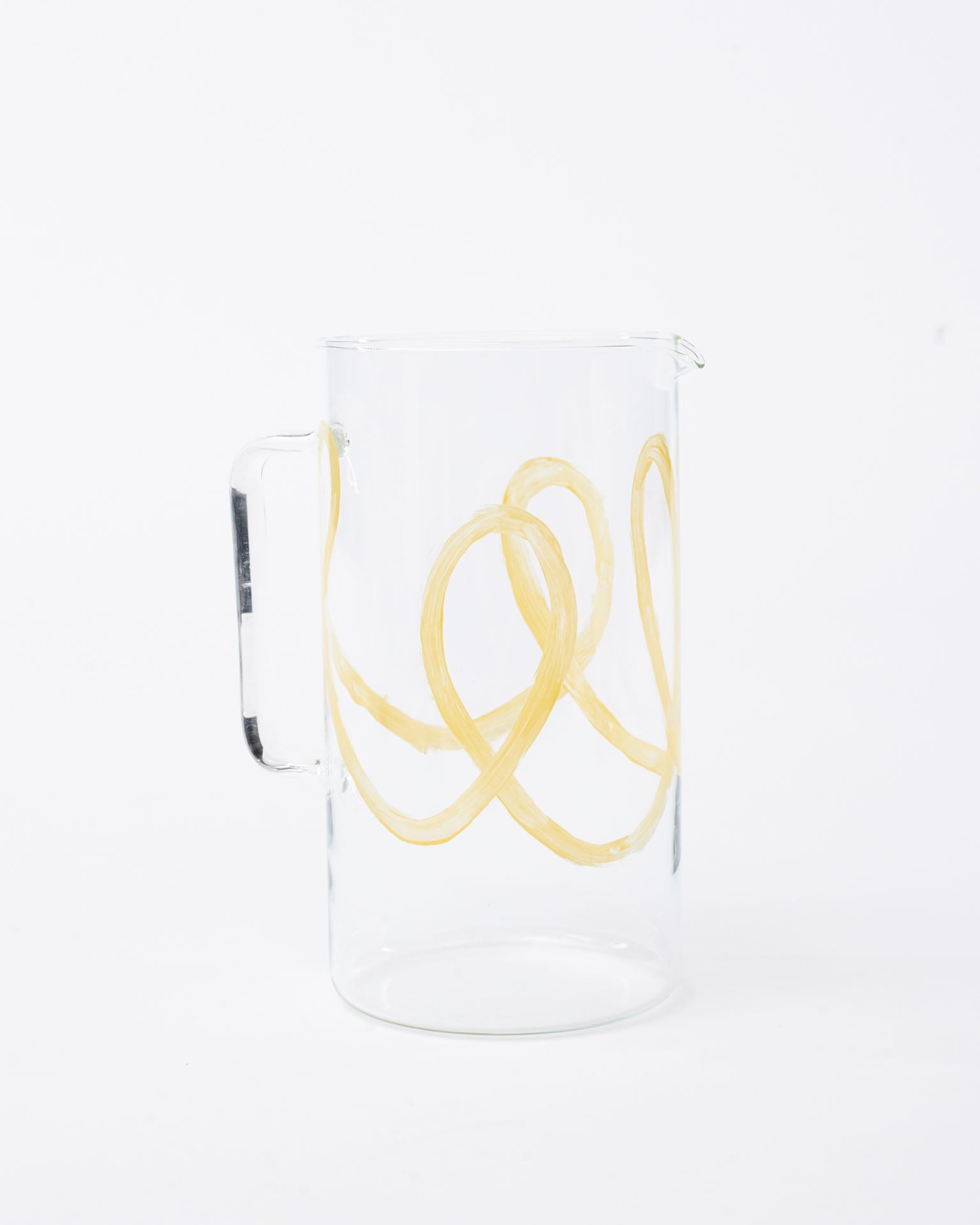 Glass pitcher yellow swirl design in white background