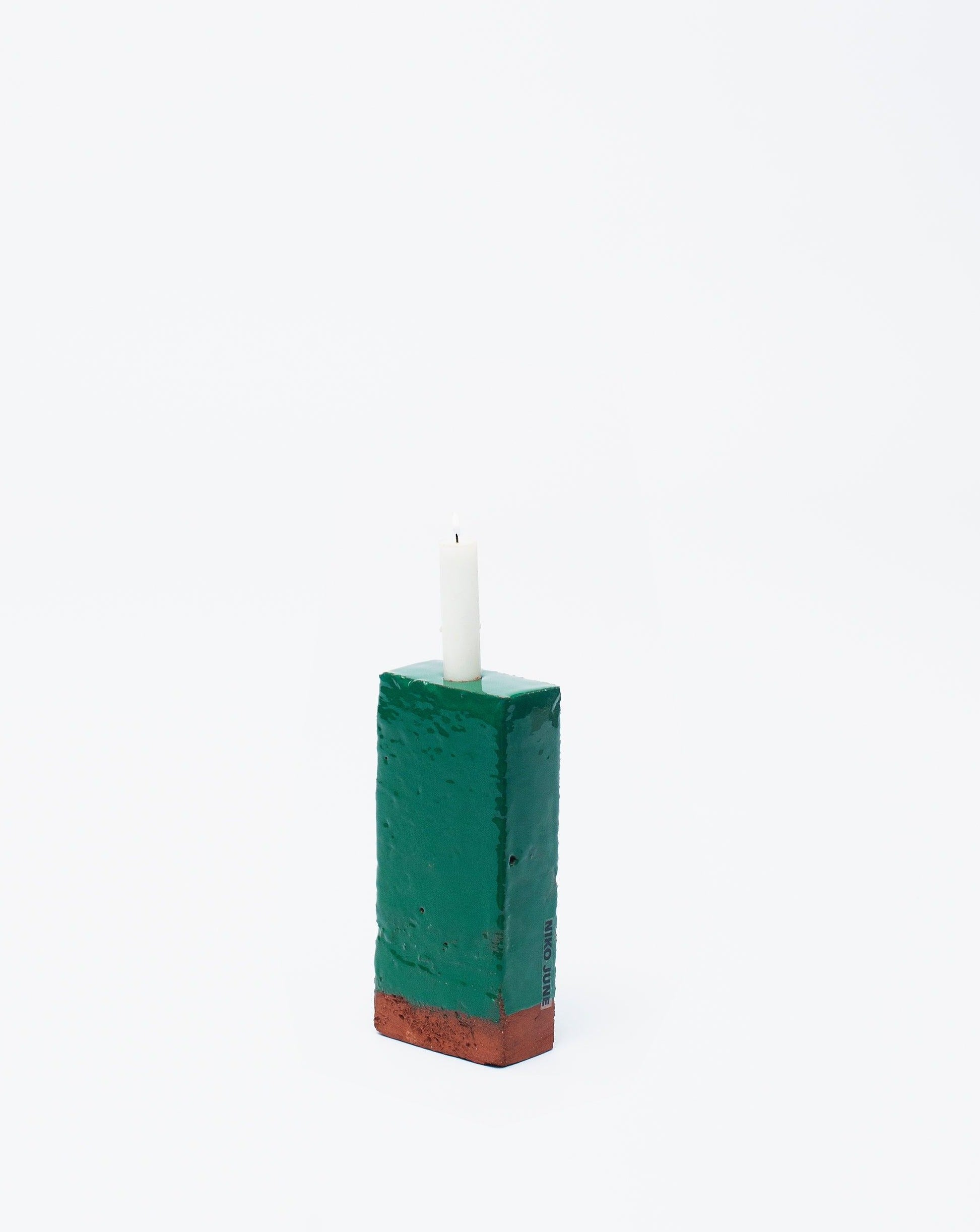 Handmade green brick ceramic candle holder in white glaze in white background