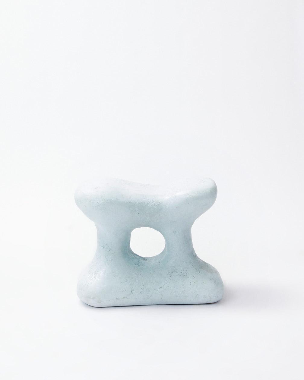 Hand-carved collectible white stool by NIKO JUNE in front position in white background