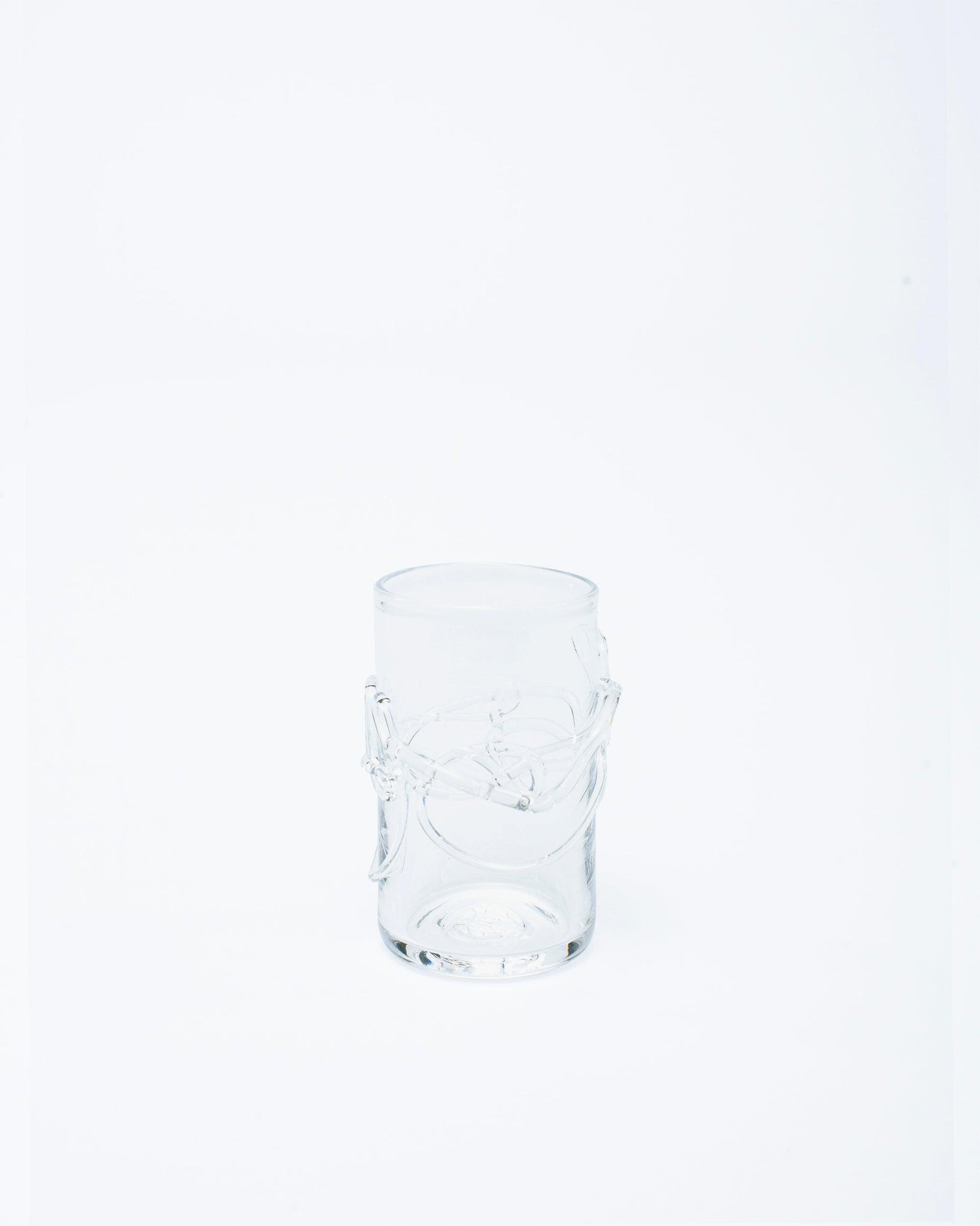 Hand blown glass with melted glass details on a white studio background
