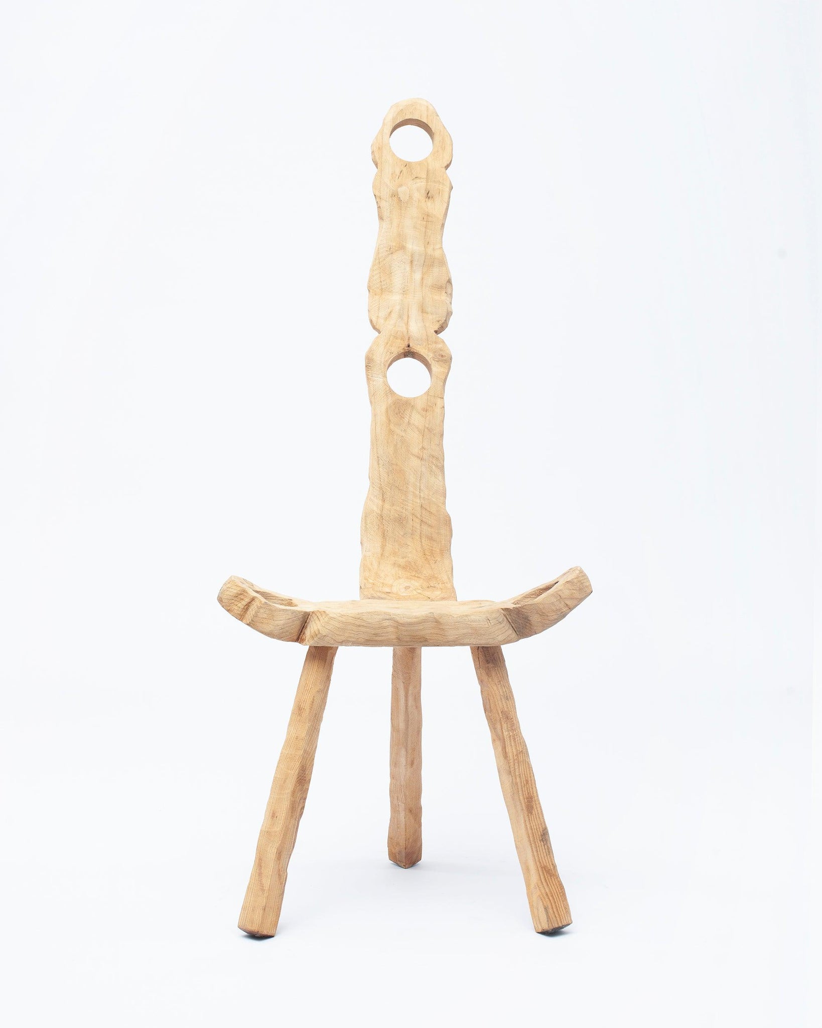 Hand-carved wooden collectible chair by NIKO JUNE with front view in white background