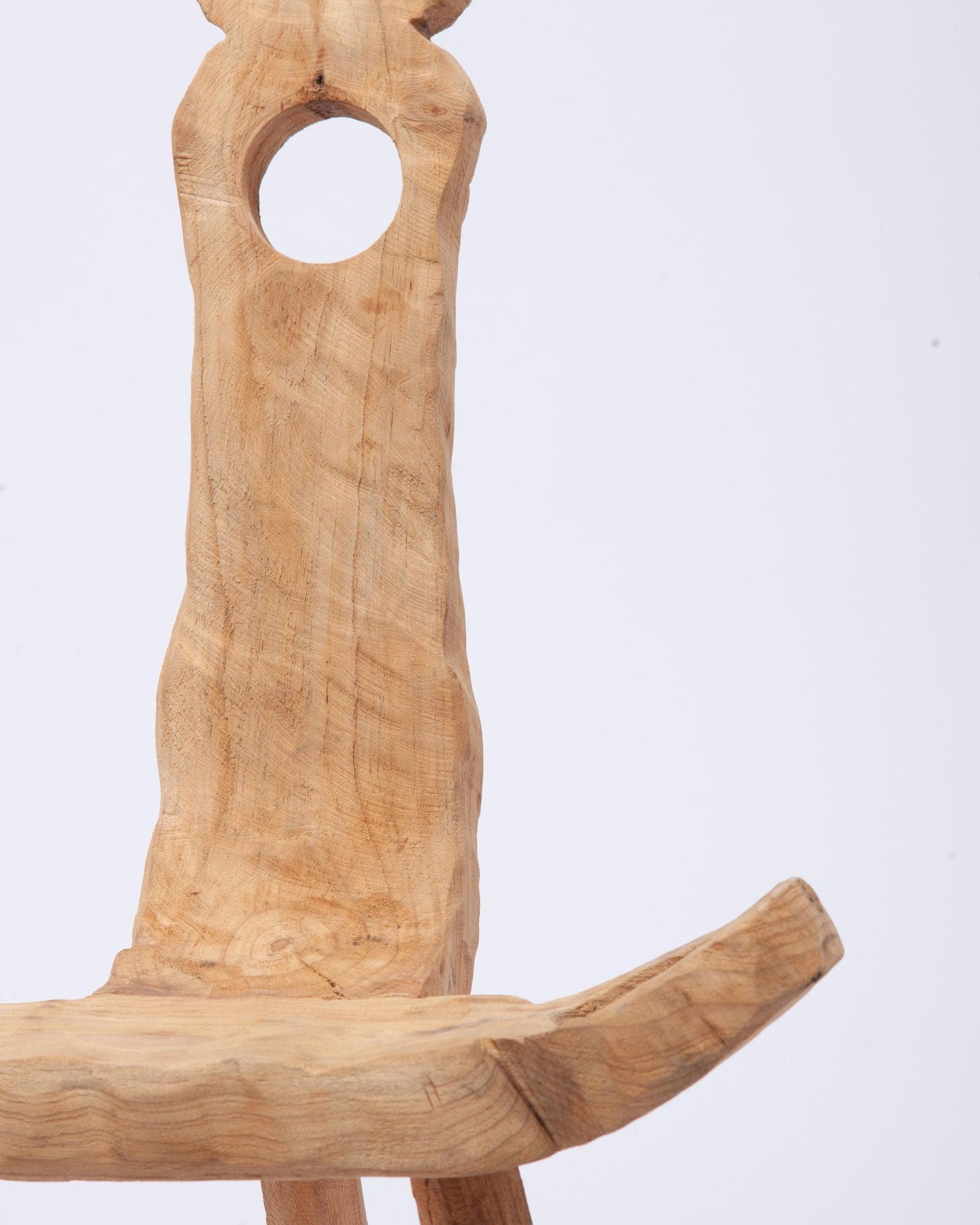 Close-up view of the seat and part of the hand-carved wooden collectible frame in white background
