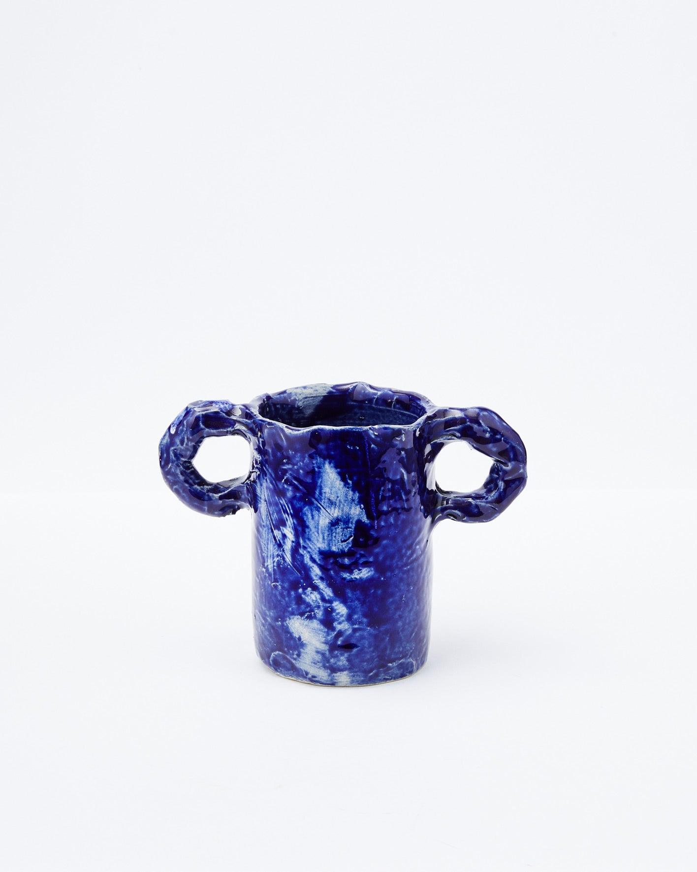 Dark blue modern ceramic vase with two handles on a white background