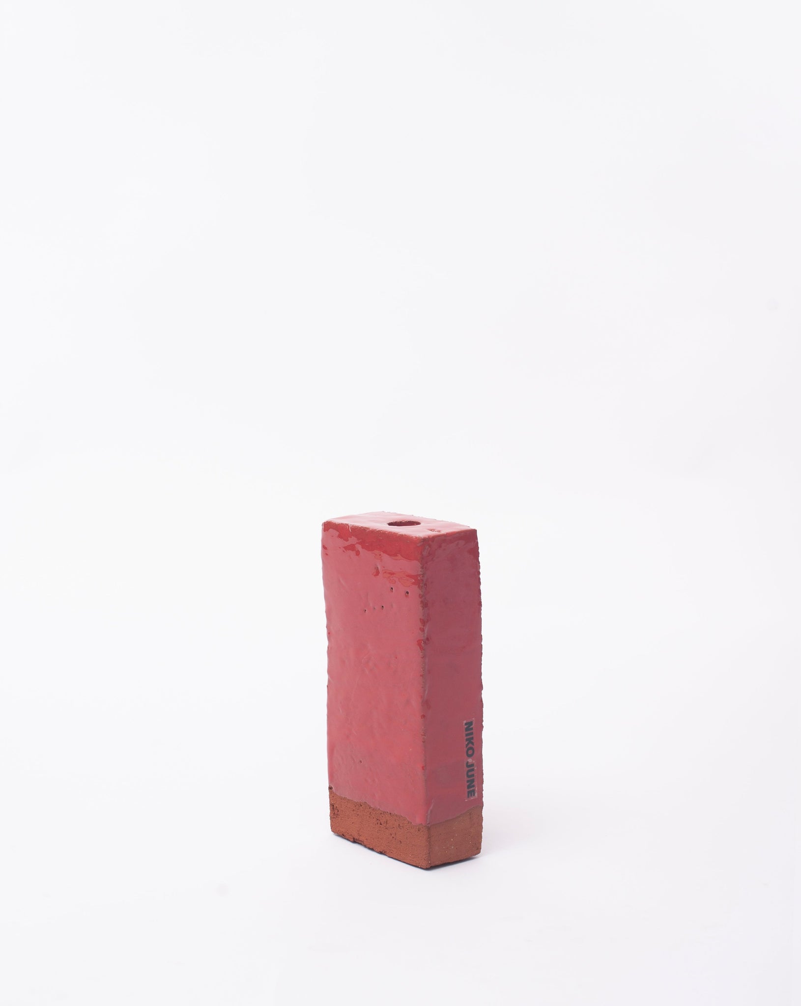 Handmade red brick ceramic candle holder in white glaze in white background with right side view